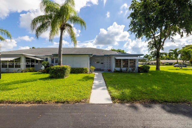 single story home featuring a front yard