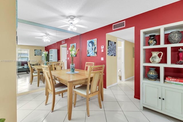 dining room featuring light tile patterned floors, a textured ceiling, and ceiling fan