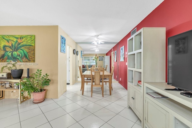 dining room with ceiling fan, a textured ceiling, and light tile patterned floors