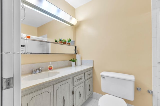 bathroom with vanity, toilet, an enclosed shower, and tile patterned floors