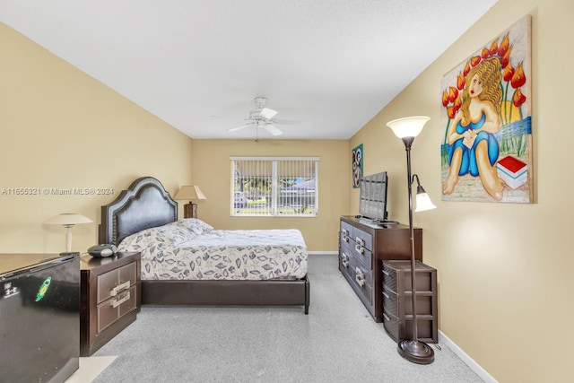 bedroom featuring light carpet and ceiling fan