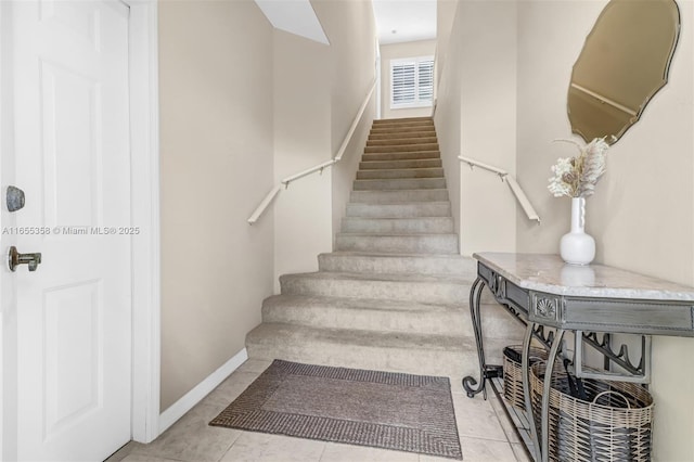 stairs with tile patterned flooring and baseboards