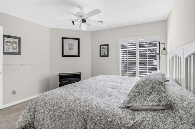 carpeted bedroom with visible vents, baseboards, and a ceiling fan