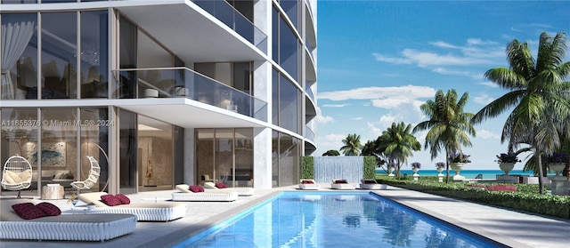 17901 Collins Unit Sf4, Sunny Isles Beach, FL 33160 - back of property with an outdoor pool, a patio area, and a balcony