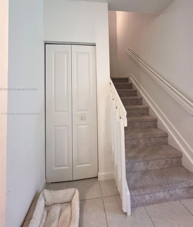 stairs with tile patterned floors