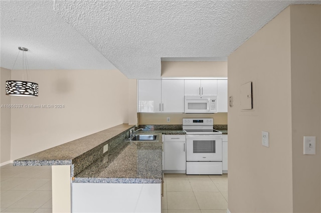 kitchen featuring white cabinets, decorative light fixtures, white appliances, sink, and kitchen peninsula