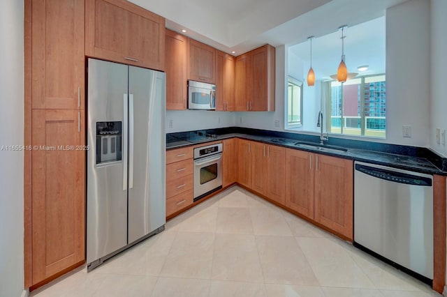 kitchen with light tile patterned flooring, pendant lighting, stainless steel appliances, and sink