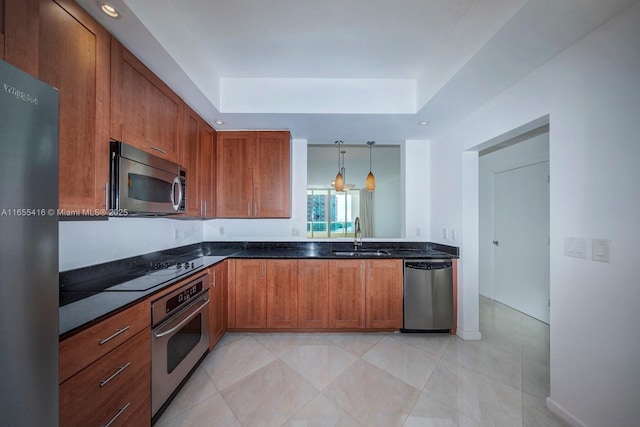 kitchen with sink, light tile patterned floors, stainless steel appliances, and hanging light fixtures