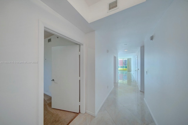 corridor featuring light tile patterned flooring