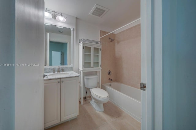 full bathroom featuring tile patterned floors, vanity, tiled shower / bath, and toilet