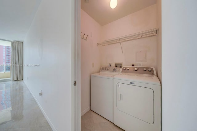 clothes washing area featuring independent washer and dryer and light tile patterned floors