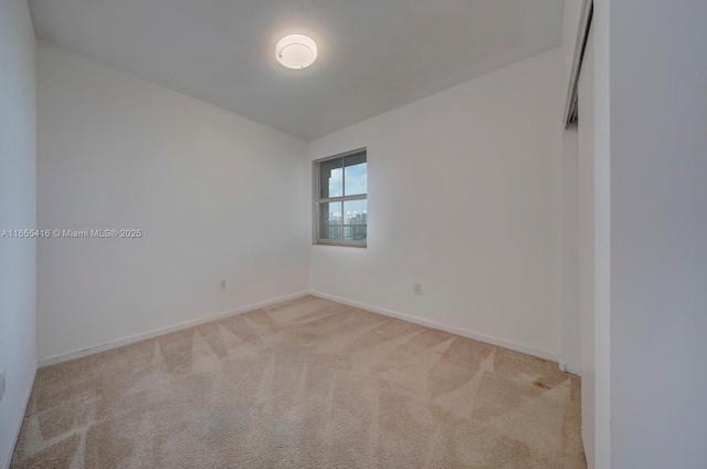 spare room with light colored carpet