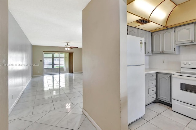 kitchen with white appliances, a ceiling fan, gray cabinetry, light tile patterned flooring, and light countertops