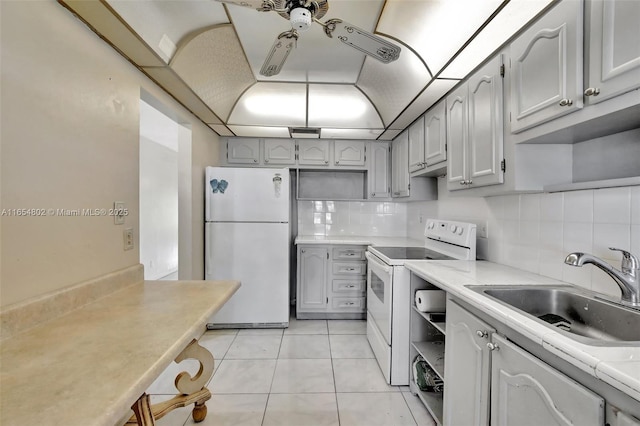 kitchen featuring white appliances, a sink, open shelves, and backsplash