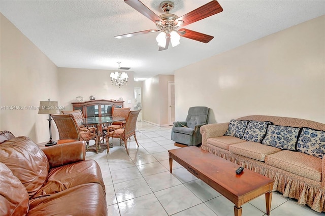 living area featuring light tile patterned floors, a textured ceiling, and ceiling fan with notable chandelier