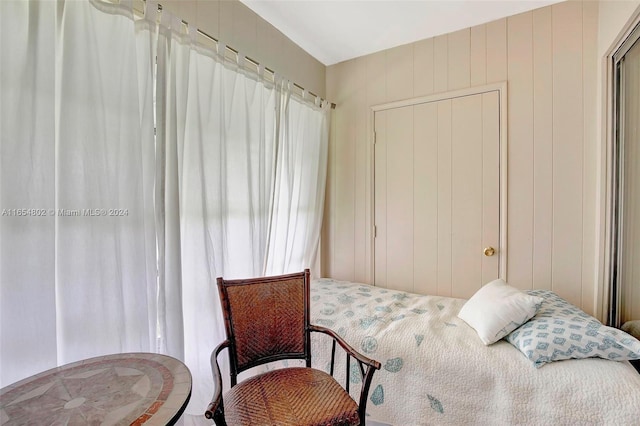 bedroom with wood walls