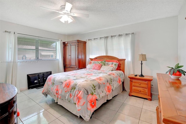 bedroom with light tile patterned flooring, a textured ceiling, and a ceiling fan