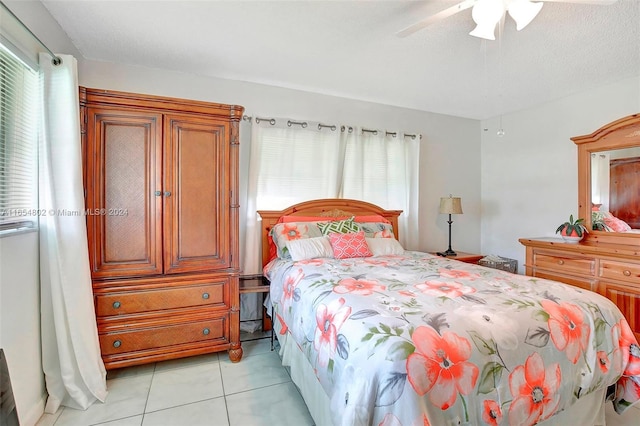 bedroom featuring light tile patterned flooring and a ceiling fan