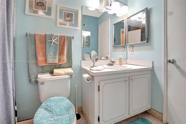 full bathroom featuring vanity, baseboards, tile patterned flooring, a shower, and toilet