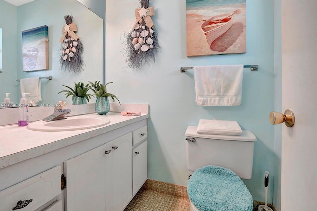 bathroom featuring tile patterned floors, toilet, and vanity