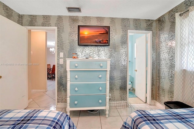 tiled bedroom with visible vents and a textured ceiling