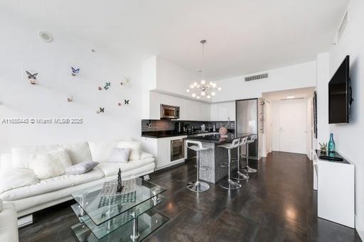 living room featuring a notable chandelier