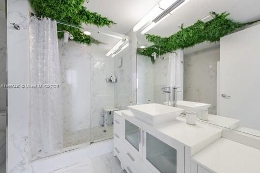 bathroom with vanity and walk in shower