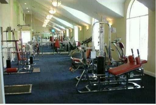 gym with lofted ceiling and carpet flooring