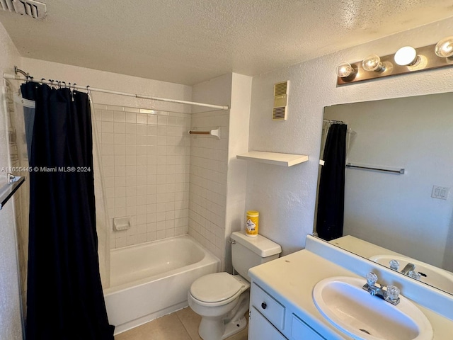 full bathroom with shower / tub combo, a textured ceiling, toilet, vanity, and tile patterned flooring