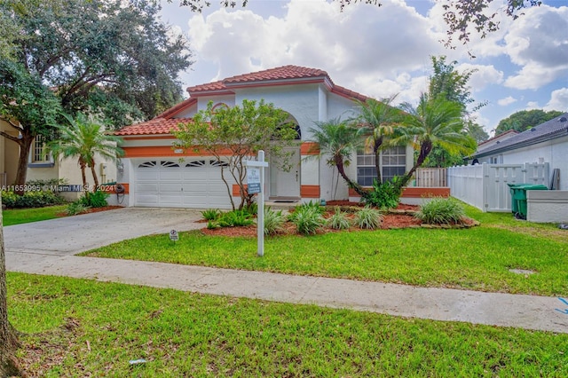 mediterranean / spanish house featuring a front lawn and a garage