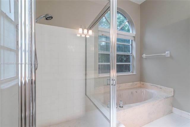 bathroom with tile patterned floors and separate shower and tub