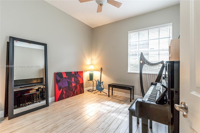 living area with ceiling fan and light hardwood / wood-style flooring