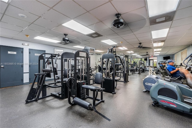 workout area featuring a drop ceiling and ceiling fan