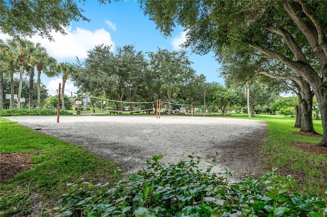 view of home's community with a lawn and volleyball court