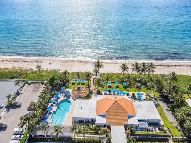 drone / aerial view featuring a beach view and a water view