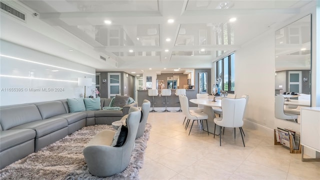 living room with coffered ceiling, light tile patterned floors, beam ceiling, and ornamental molding