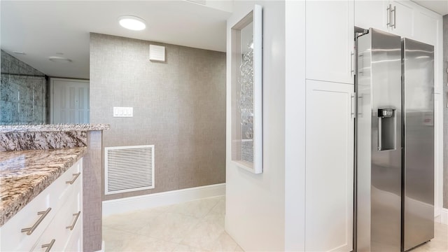 bathroom with tile patterned flooring and vanity