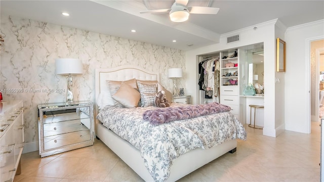 tiled bedroom with crown molding, ceiling fan, and a closet