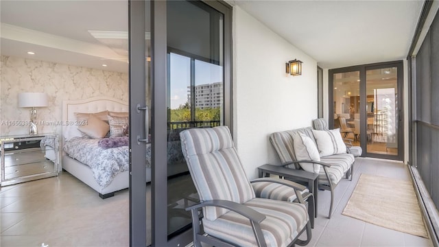 tiled bedroom with a wall of windows and access to exterior