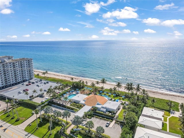 birds eye view of property featuring a beach view and a water view