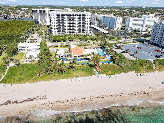 aerial view with a water view and a beach view