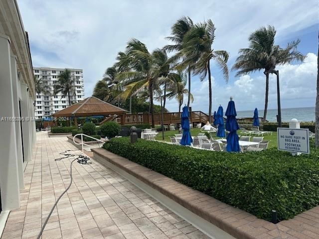 view of property's community with a water view and a gazebo