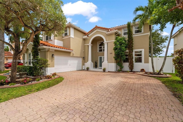 mediterranean / spanish-style home featuring a garage