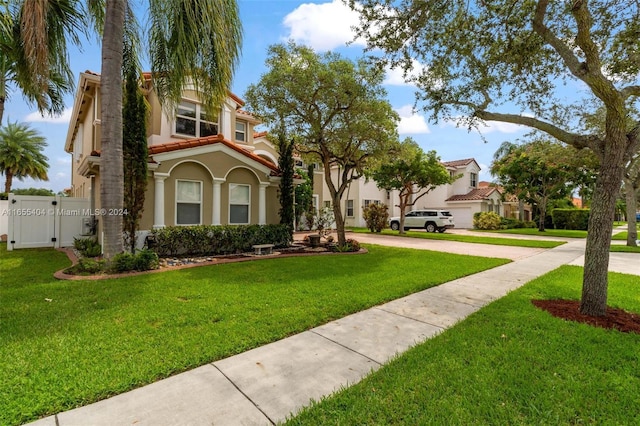 mediterranean / spanish-style home with a front lawn