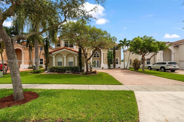 mediterranean / spanish house with a front yard