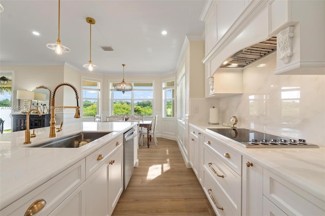 kitchen featuring white cabinetry, sink, light hardwood / wood-style flooring, pendant lighting, and custom range hood