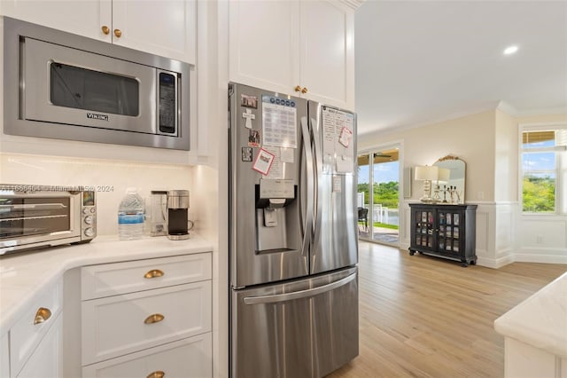 kitchen featuring white cabinetry, plenty of natural light, light hardwood / wood-style flooring, and appliances with stainless steel finishes