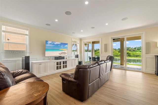 living room featuring light hardwood / wood-style flooring and crown molding