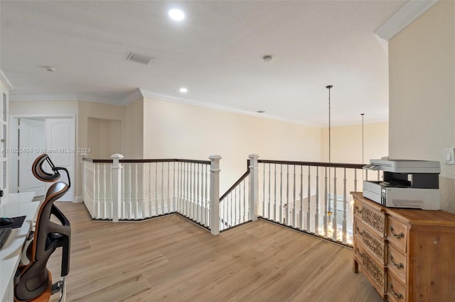 hallway featuring light hardwood / wood-style floors and crown molding