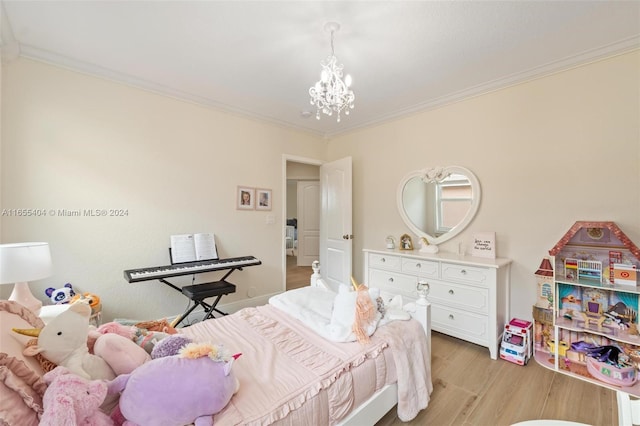 bedroom with a notable chandelier, light hardwood / wood-style floors, and ornamental molding